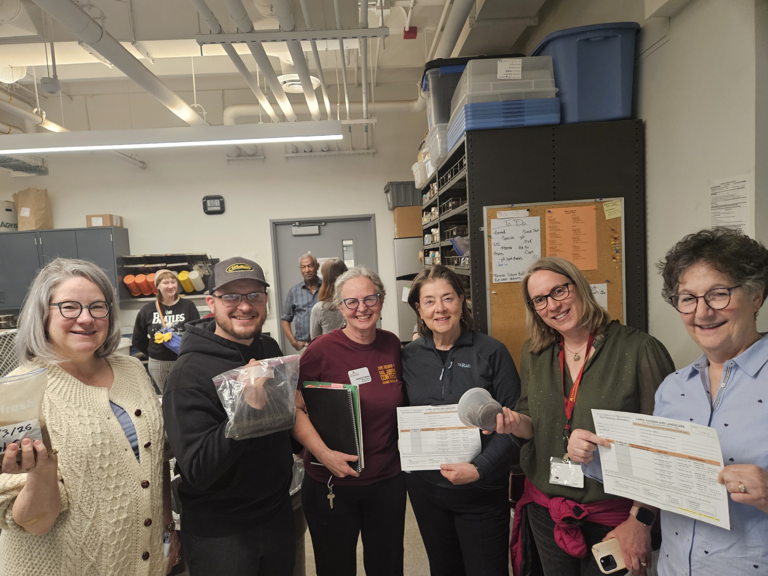 A group of six people shown at their visit to the soil lab.
